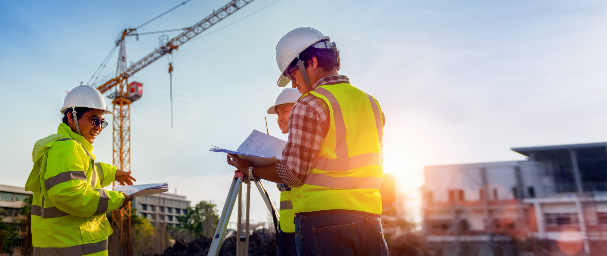 Construction engineers discussion with architects at construction site or building site of highrise building with Surveying for making contour plans is a graphical representation of the lay in land.